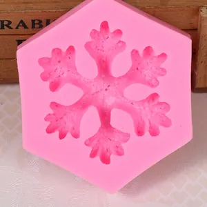 Detailed view of a pink snowflake-shaped silicone mold for DIY baking and crafts