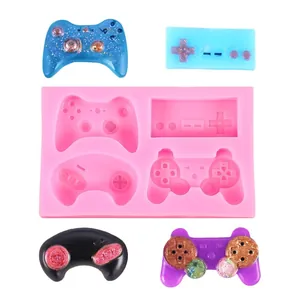 Close-up of pink silicone game controller mold with colorful resin finished pieces