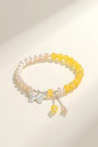 Close-up of natural freshwater pearl bracelet with silver butterfly charm