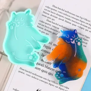 Detailed view of a cute cat-shaped silicone mold alongside a colorful resin sample