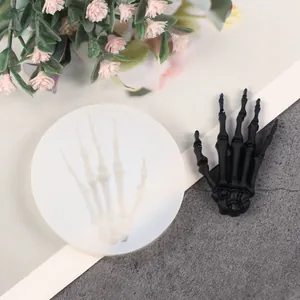Detailed view of skeletal hand silicone mold and the finished black resin product