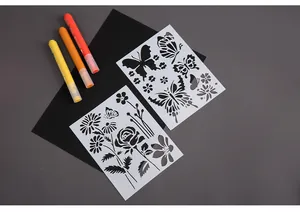 Detailed view of butterfly and flower PET hollow stencils with markers and paper