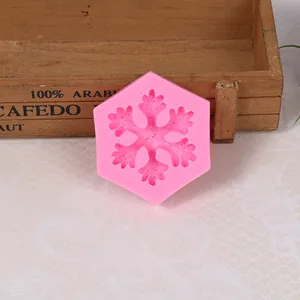 Detailed view of a pink hexagonal snowflake silicone mold for cake decorating