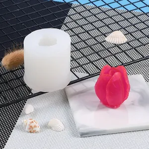 Detailed view of tulip flower silicone mold next to a finished pink candle craft