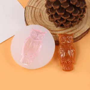 Detailed view of the owl silicone mold alongside a finished golden resin owl craft piece