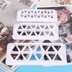 Set of three white plastic geometric triangle cookie cutters for baking decoration