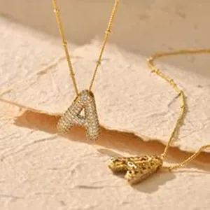 Gold initial A pendant necklace with sparkling pavé crystals and bead chain detail