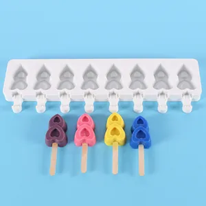 Detail view of white eight-cavity silicone heart popsicle mold with colorful finished ice pops