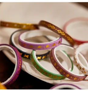 Close-up of decorative washi tape set with elegant gold foil geometric patterns