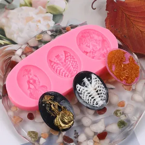 Detailed view of pink DIY silicone mold with finished skeleton and angel resin pieces