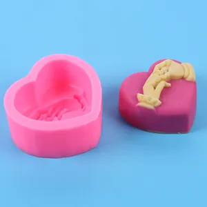 Heart shaped silicone mold featuring a holding hands relief with finished product
