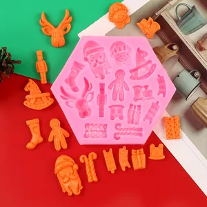 Pink silicone Christmas mold featuring Santa, reindeer, and gingerbread man shapes.