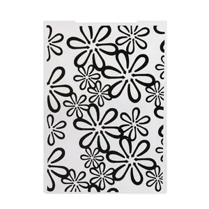 Detailed macro view of plastic fondant embossing folder with floral daisy patterns
