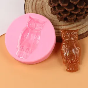 Detailed view of pink owl silicone mold alongside a finished brown glittery resin owl