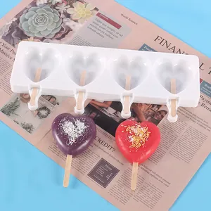 Macro detail of heart-shaped silicone mold with finished colorful popsicles.