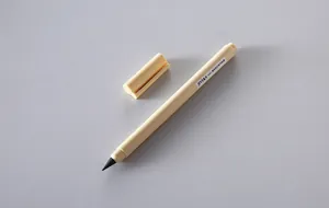 Detail of a minimalist cream-colored inkless everlasting pencil with its cap removed.