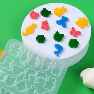 Detailed view of mini animal silicone mold with colorful DIY resin jewelry samples