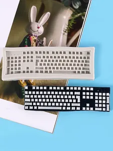 Detailed view of the keyboard silicone mold and a finished black and white resin piece.