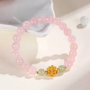Elegant pink strawberry crystal bracelet with gold lotus charm and jade beads for women.