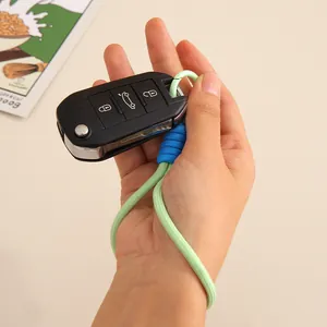Dragonne de poignet tressée faite main en vert menthe et bleu pour téléphone ou clés