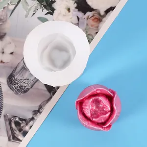 Detailed view of tulip flower silicone mold with finished pink wax candle decoration