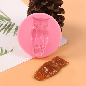 Detailed view of pink silicone owl mold next to a finished glittery brown owl figurine