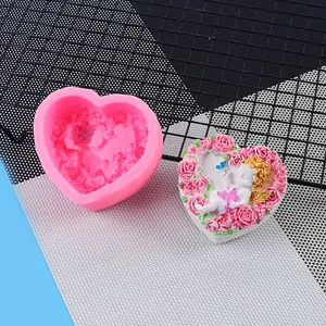 Detailed view of heart silicone mold and finished angel rose relief cake decoration
