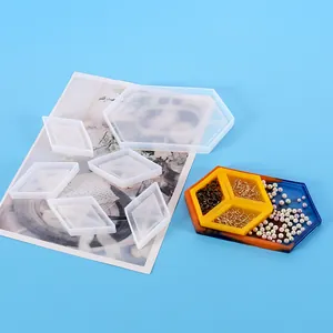 Close-up of DIY hexagonal and diamond silicone molds with finished resin storage tray sample.