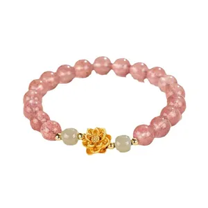 Elegant strawberry quartz beaded bracelet featuring a gold lotus flower and jade stone accents