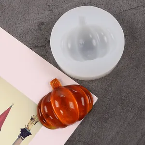Detailed close-up showing a 3D pumpkin shaped silicone mold with an orange resin sample
