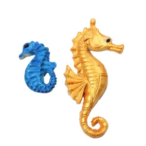 Detailed view of large golden and small blue seahorse-shaped fondant silicone molds