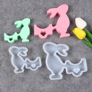 Close-up of Easter bunny silicone molds and finished resin candle holders.