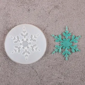 Top view detail of snowflake silicone mold and green resin finished product