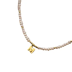 Vintage freshwater rice pearl necklace with a gold-toned letter M pendant detail