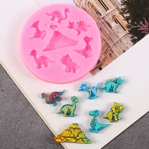 Detailed view of pink dinosaur and volcano silicone mold with colorful finished pieces
