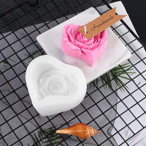 Detailed close-up of heart-shaped rose silicone mold with finished pink candle