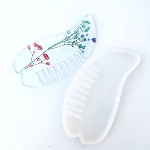 Detailed view of DIY resin comb mold showing the silicone mold and floral sample