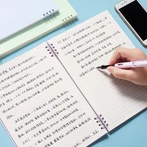A5 Morandi spiral notebook with lined paper being used with a matching pen