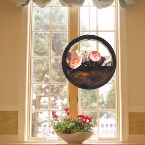 Elegant circular epoxy resin wall hanging planter shown in a bright cozy window