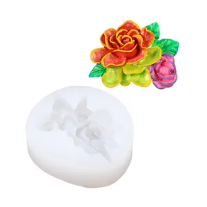 Detailed white silicone floral mold alongside a vibrant finished plaster rose accessory