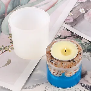 Detailed view of a cylindrical silicone mold and a finished resin shell candle holder