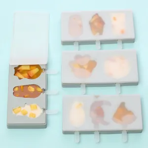 Detail view of multi-shaped silicone popsicle molds with lids and wooden sticks.