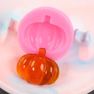 Close-up detail of a pink 3D pumpkin silicone mold with a translucent orange resin pumpkin