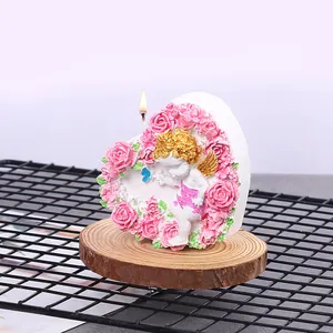 Close-up of heart silicone mold showing intricate angel and pink rose 3D relief detail
