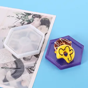 Detailed view of hexagonal silicone mold and finished purple resin tray product.