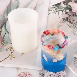 Detailed view of cylindrical silicone mold with finished seashell resin holder