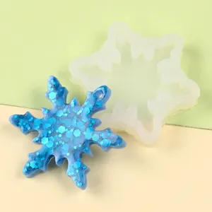 Detailed view of a snowflake-shaped silicone mold with a glittery blue resin cast