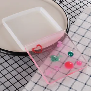 Close-up of square silicone coaster mold and finished DIY mirror epoxy resin coaster