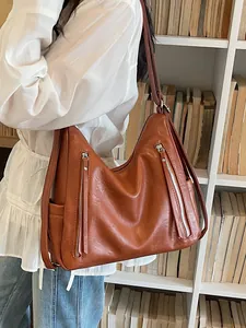 Brown faux leather hobo shoulder bag with zipper details for women's daily commute.