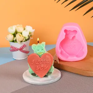 Detail of pink silicone bear mold and finished heart candle for Valentine's Day